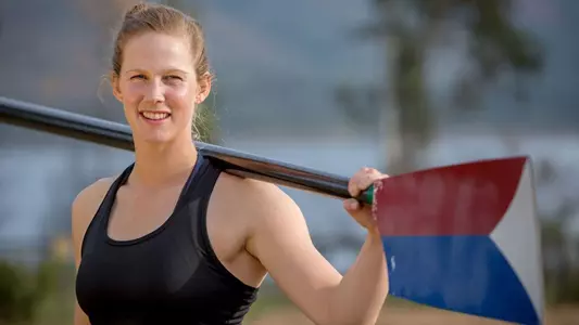Grace Latz holds a United States oar