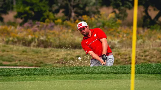 Spencer Turtz hits out of the bunker at the Badger Invitational