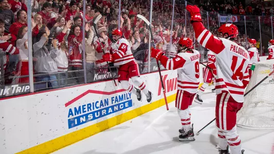 Anthony Kehrer jumps on the glass in front of the student section after a win