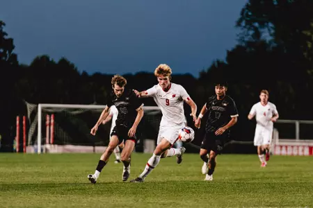 Markie Hrvojevic runs next to a Washington defender