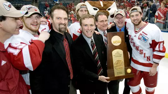 MILWAUKEE, WI - APRIL 8: Head coach Mike Eaves (holding trophy) of the Wisconsin Badgers poses with his assistant coaches after winning the Naitonal Championship against the the Boston College Eagles during the NCAA Frozen Four Finals on April 8, 2006 at the Bradley Center in Milwaukee, Wisconsin. Wisconsin beat Boston College 2-1. (Photo by David Stluka)