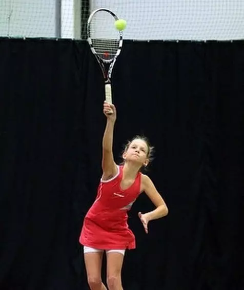 Maria Sholokhova playing tennis as a young kid