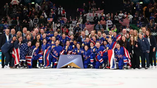 MILAN, ITALY - FEBRUARY 19: Gold medalist Team United States players, coaching staffs and team staffs pose after the medal ceremony for the Ice Hockey Women following the Women's Gold Medal match between the United States and Canada on day 13 of the Milano Cortina 2026 Winter Olympic games at Milano Santagiulia Ice Hockey Arena on February 19, 2026 in Milan, Italy. (Photo by Gregory Shamus/Getty Images)