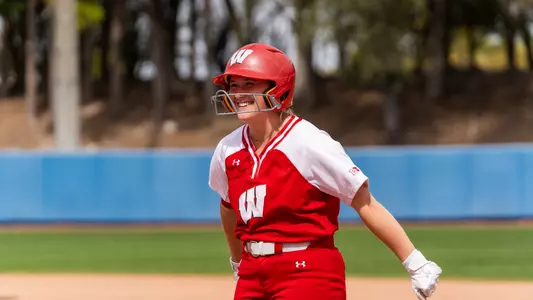 Kendra Lewis celebrates at first base in Florida.