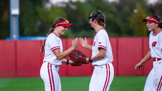 Alivia Bark and Shelby Jacobson meet in the circle during a fall ball game.