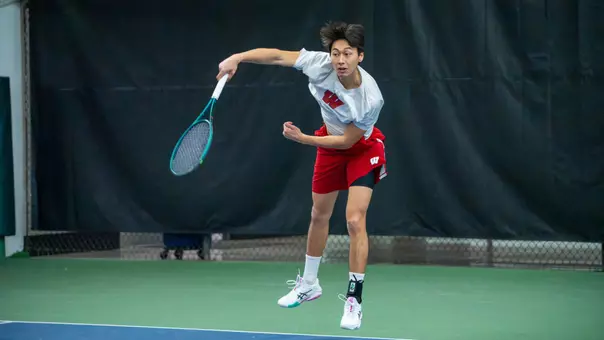 Edouard Aubert serves the ball