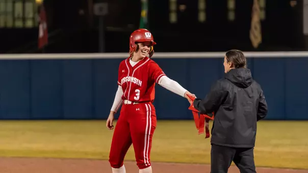 Emily Bojan celebrates at first base.