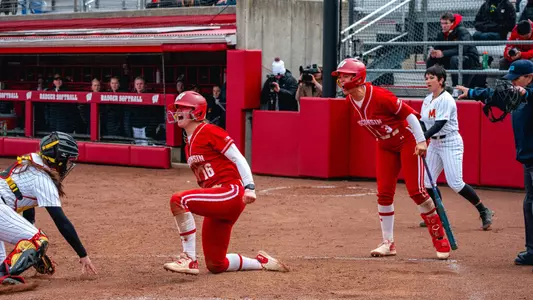 Hannah Conger and Emily Bojan celebrate at home plate against Maryland.
