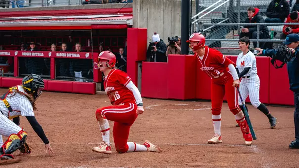 Hannah Conger and Emily Bojan celebrate at home plate against Maryland.