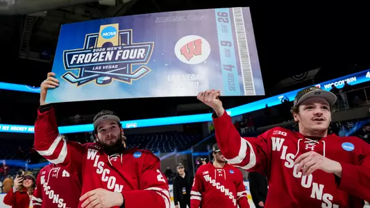 Jack Horbach and Aiden Dubinsky hold the Frozen Four ticket