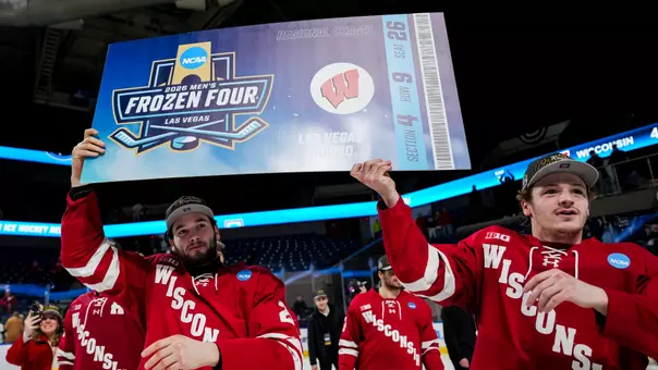 Jack Horbach and Aiden Dubinsky hold the Frozen Four ticket