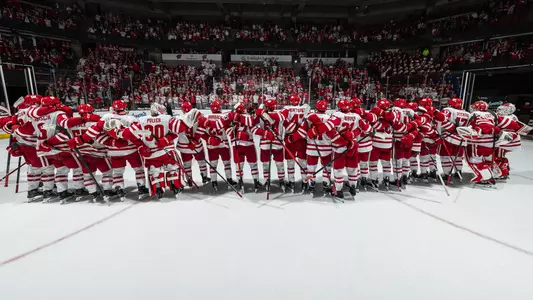 The team celebrates a win at the Kohl Center