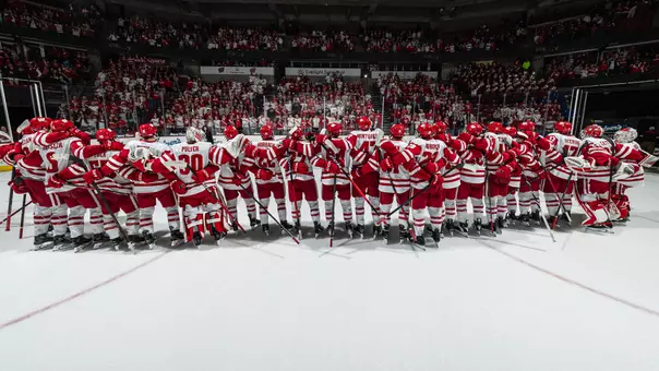 The team celebrates a win at the Kohl Center