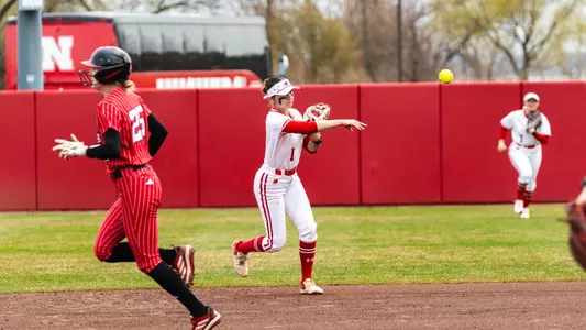 Kaylie Whidden throws to first base against Nebraska.