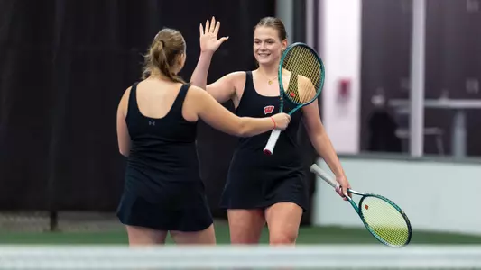 Maria Sholokhova and Ekaterina Ivanova celebrate a doubles win