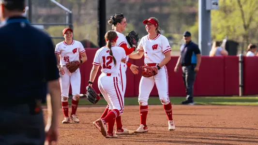 Badgers meet in the circle against St. Thomas.