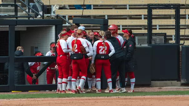 Badgers huddle after an inning versus Purdue.