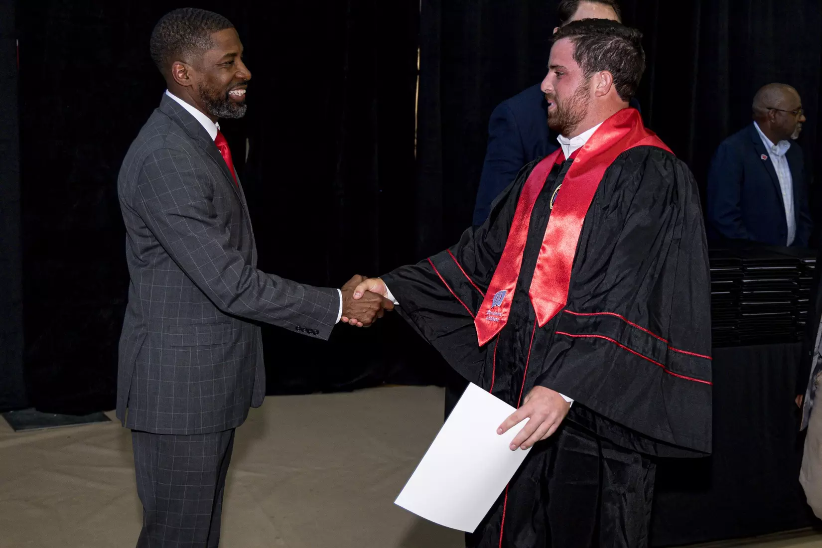Interim Director of Athletics Marcus Sedberry congratulates men's golfer Spencer Turtz at the Class of 2026 Student-Athlete Graduation Ceremony