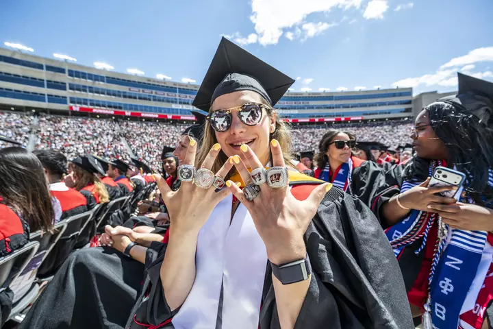 Women's Hockey player Lacey Eden shows off her rings at UW Madison's 2026 spring commencement