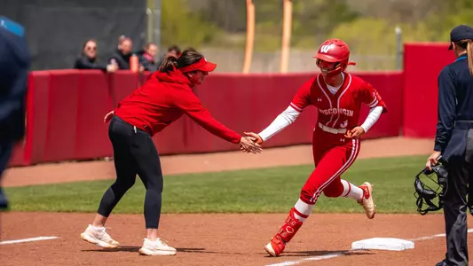 Emily Bojan and Yvette Healy meet at third base after HR.