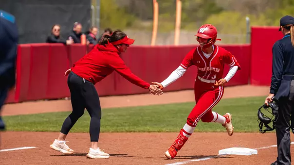 Emily Bojan and Yvette Healy meet at third base after HR.