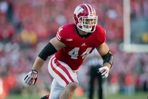 Chris Borland playing linebacker in a red Wisconsin helmet and red jersey