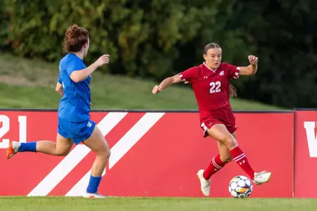 Jenna Baumann moving with the ball against a defender - Wisconsin Women's Soccer vs BYU