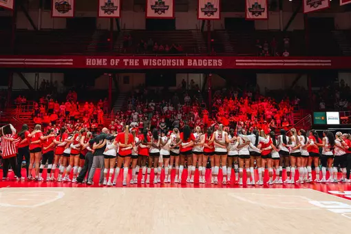Volleyball alumni and current team singing Varsity