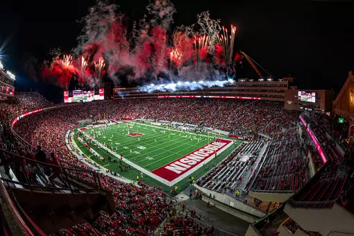 Red and white fireworks light up Camp Randall Stadium while the team runs out after halftime at the Homecoming football game versus Iowa at the University of Wisconsin–Madison on Oct. 11, 2025. (Photo by Taylor Wolfram / UW–Madison)