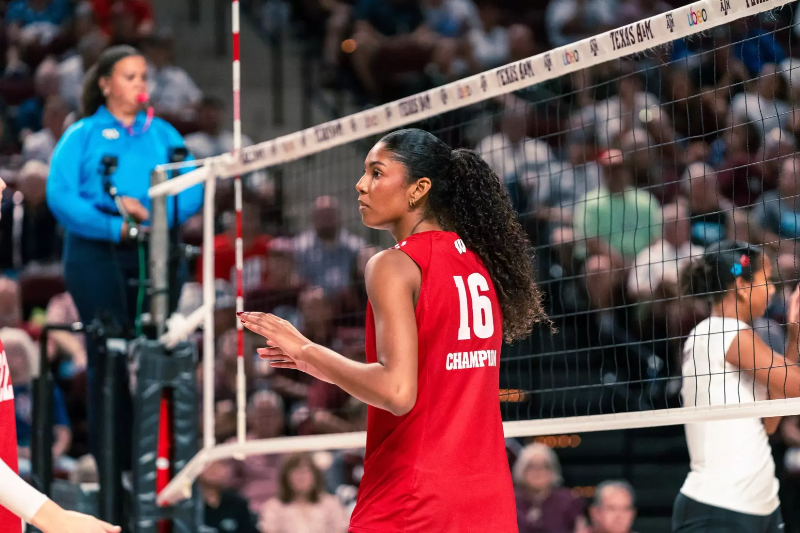 Wisconsin outside hitter Decelise Champion (#16) stands near the net preparing for the next rally against Texas A&M.