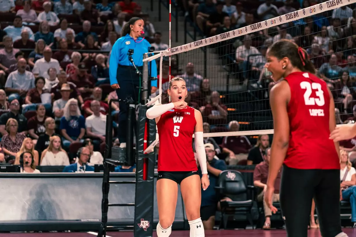 Wisconsin outside hitter Eva Travis (#5) reacts with an open-mouthed expression while teammate Grace Lopez (#23) turns to celebrate during play against Texas A&M.
