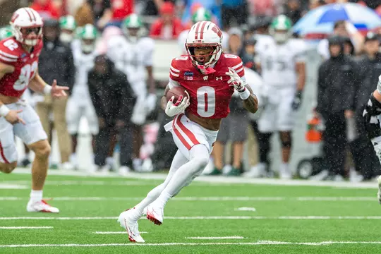 Tyrell Henry catches a pass against Eastern Michigan