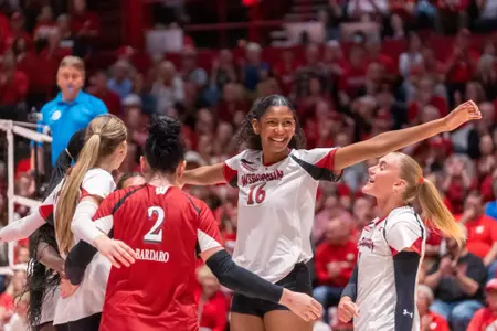 Decelise Champion celebrates with her Wisconsin teammates after winning a point against Oregon.