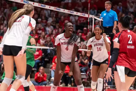 Jaela Auguste shouts in celebration alongside Decelise Champion and Anna Bardaro after a point against Oregon.
