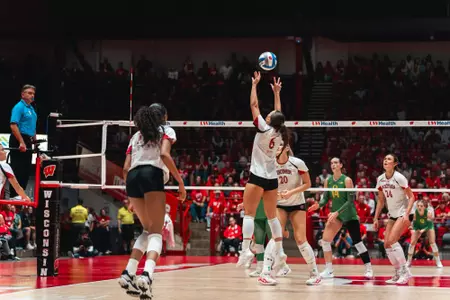 Isabelle Hoppe jumps to set the ball near the net during Wisconsin’s match against Oregon.