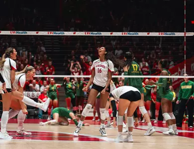 Decelise Champion celebrates a Wisconsin point as Oregon players regroup across the net.