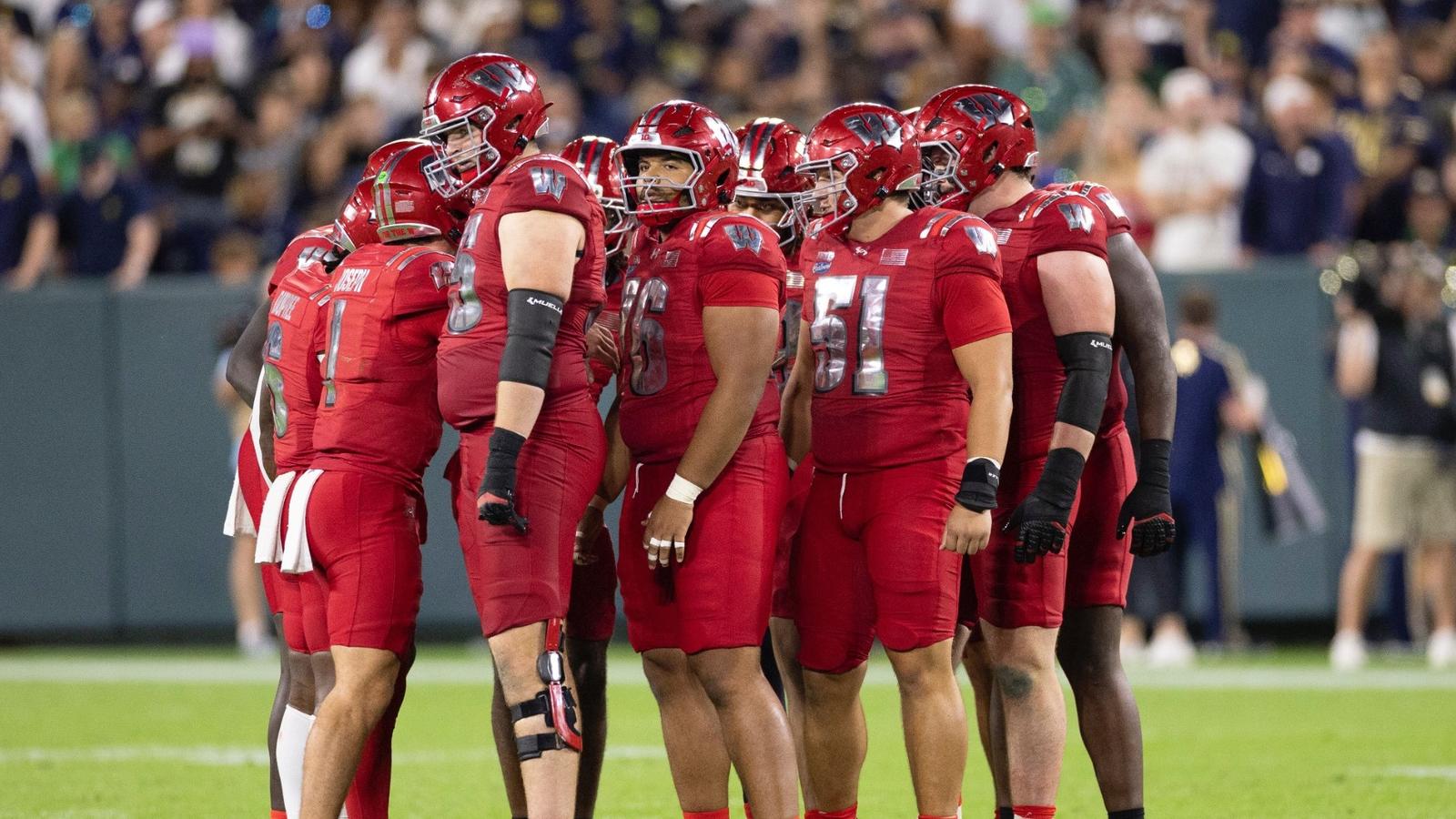 Wisconsin huddles during a 41-13 loss against Notre Dame at Lambeau Field on Sept. 6, 2026.