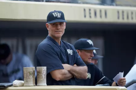 Wake Forest Demon Deacons head coach Tom Walter (16) watches from the dugout during the game against the Davidson Wildcats at David F. Couch Ballpark on May 7, 2019 in  Winston-Salem, North Carolina. The Demon Deacons defeated the Wildcats 11-8. (Brian Westerholt/Four Seam Images)