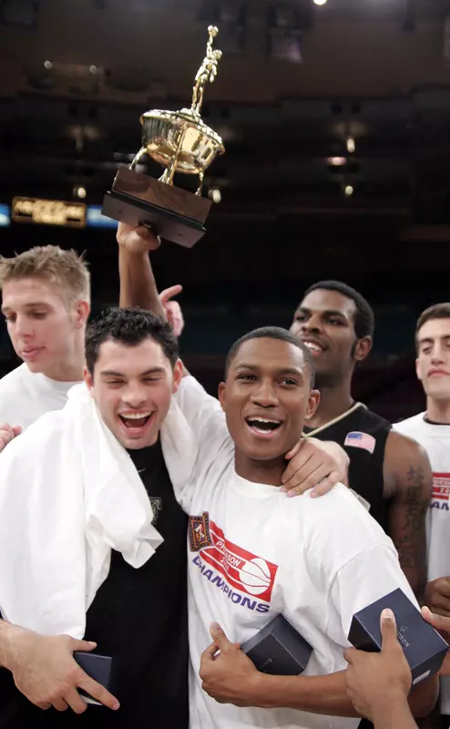 Justin Gray holds up the MVP trophy as he his joined by Richard Joyce and other teammates after defeating Arizona to win the NIT.