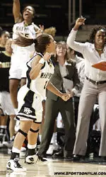 Porsche Jones and the Wake Forest bench celebrate Jone's late 3-pointer that gave the Demon Deacons a 57-55 lead on their way to a 58-55 victory over Davidson.