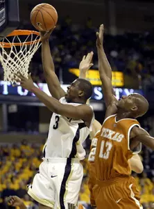 Chris Paul drives past Texas' Sydmill Harris.