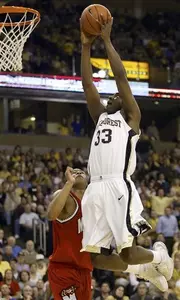Trent Strickland sails past Maryland's Chris McCray for a dunk during the first half.