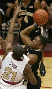 Justin Gray shoots for two second-half points as Florida State's Jason Rich attempts to defend.