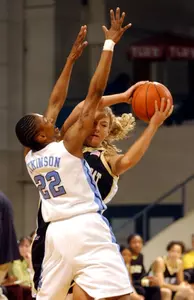 North Carolina's La'Tangela Atkinson tightly defends Liz Strunk as she brings the ball upcourt.