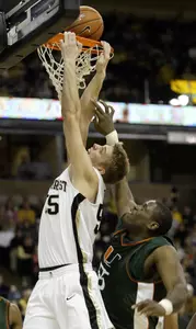 Kyle Visser dunks as he is fouled by Miami's Glenn Batemon.