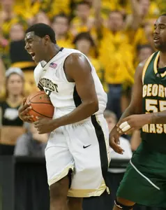 Trent Strickland celebrates late in the over time as George Mason's Jai Lewis looks on.