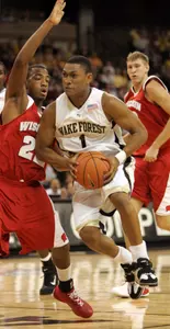 Justin Gray drives by Wisconsin's Michael Flowers in first half.