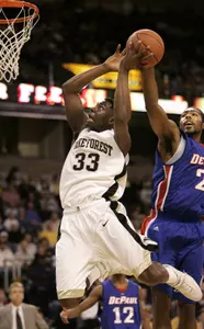 Trent Strickland has his shot blocked by Depaul's Marcus Heard during the first half.