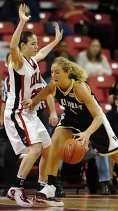 Liz Strunk drives to the basket as Maryland's Shay Doron defends during the first half.