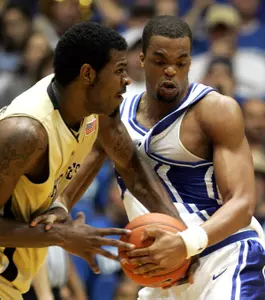 Duke's Shelden Williams battles for the loose ball with Eric Williams during the first half